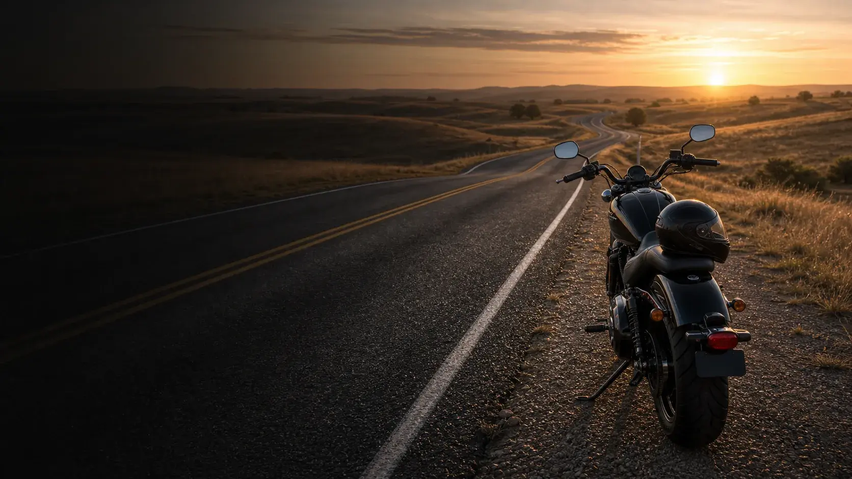 Motorcycle parked safely off an Oklahoma rural highway near rolling prairie at sunrise