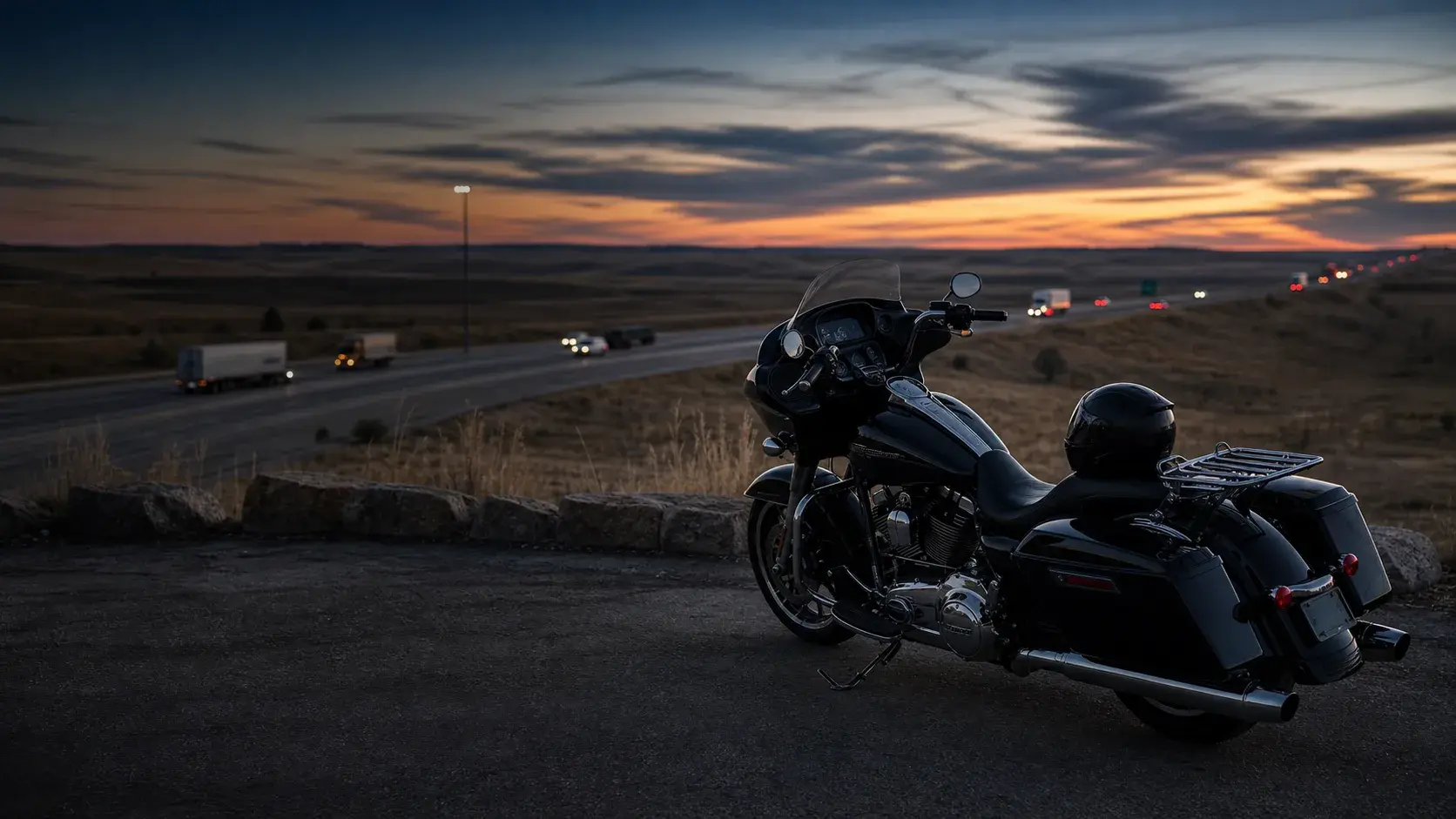 Oklahoma highway at dusk with a motorcycle parked safely on a wide paved overlook away from traffic