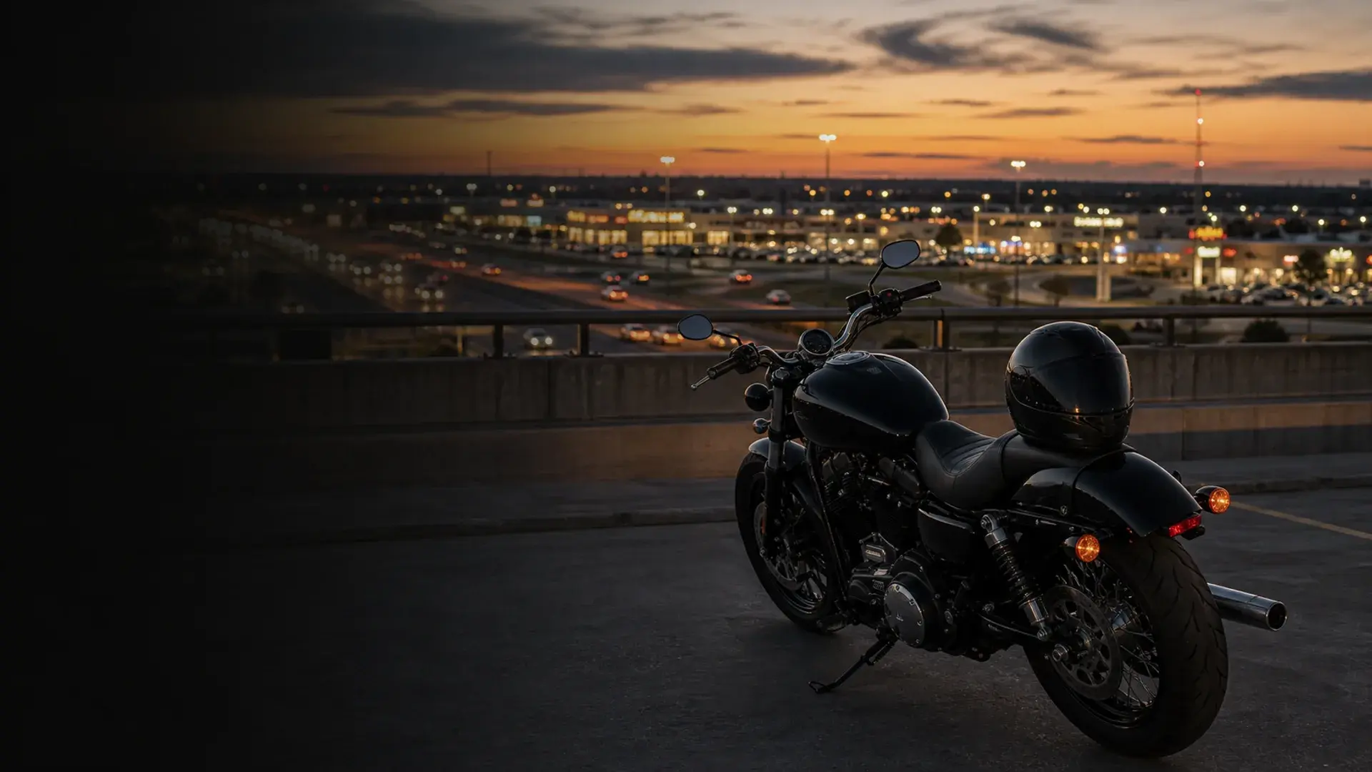 Motorcycle parked safely above a Moore retail and I-35 commuter corridor at dusk