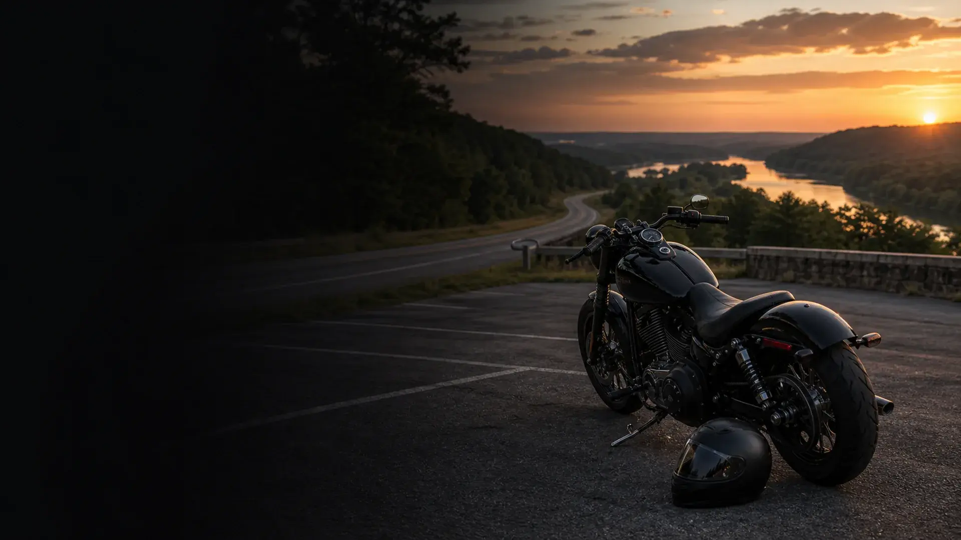 Motorcycle parked safely near a Muskogee eastern Oklahoma highway with wooded river-valley hills at dusk