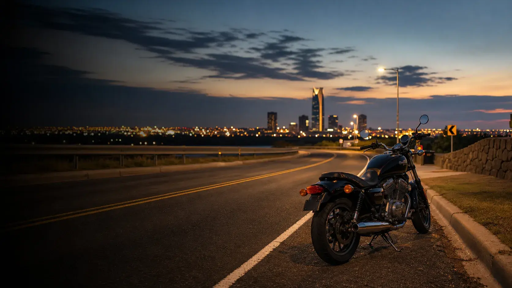 Motorcycle parked safely near an Oklahoma roadway with city route markers and open sky