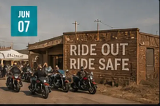 Community motorcycle ride staging outside a brick building