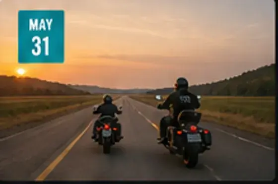 Two motorcycle riders heading toward the lake at sunset